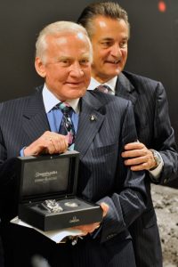 Buzz Aldrin, left, gets a watch from Stephen Urquhart, right, during a press conference at the Omega booth at the world watch and jewellery show 'Baselworld' in Basel, Switzerland, Saturday, March 28, 2009. Omega presented the 'Omega Speedmaster Professional Moonwatch Apollo 11 40th Anniversary Limited Edition' wristwatch in presence of the astronauts.