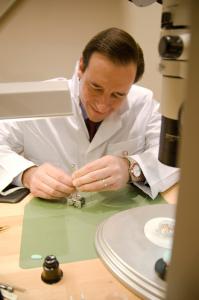 Dave Cobb, Executive Vice-President and DEputy CEO of the Vancouver Organizing Committee for the 2010 Olympic and paralympic winter games behind watchmaker bench at the OMEGA Olympic boutique in Vancouver