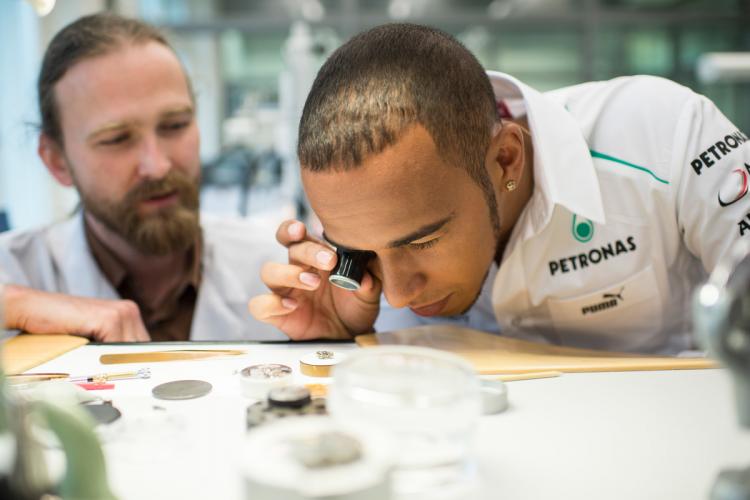 Lewis Hamilton looking at an IWC watch