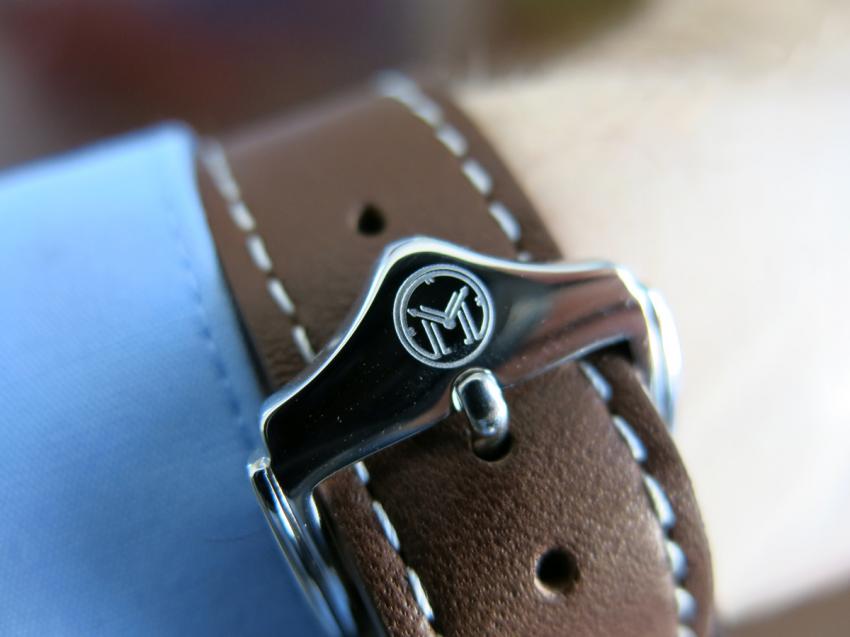 The logo of Melbourne Watch Company engraved on the buckle.