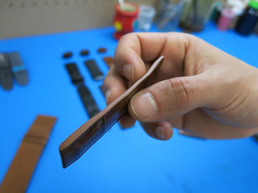 Aaron showing us the finished edge of a strap