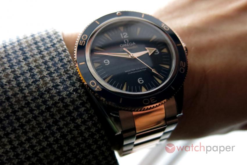 Sedna gold, blue dial, Omega Seamaster 300 on the wrist.