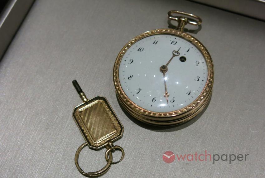 Gold pocket watch with the original winding key.