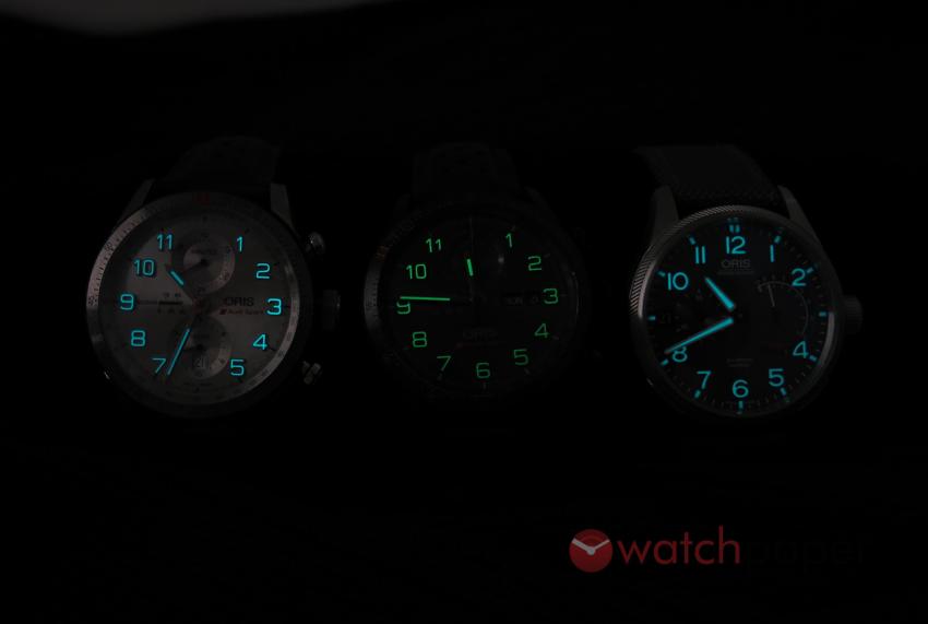 Three Oris pieces glowing in the dark: the Audi Sport Limited Edition, the Audi Sport Limited Edition II and the Pro Pilot Calibre 111.