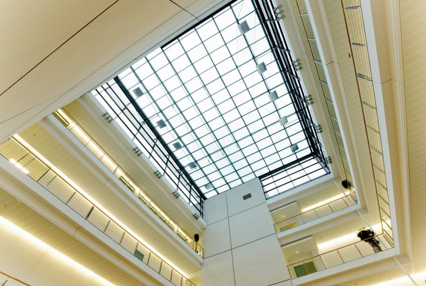 The glass roof of the atrium fills with natural light the entire building.